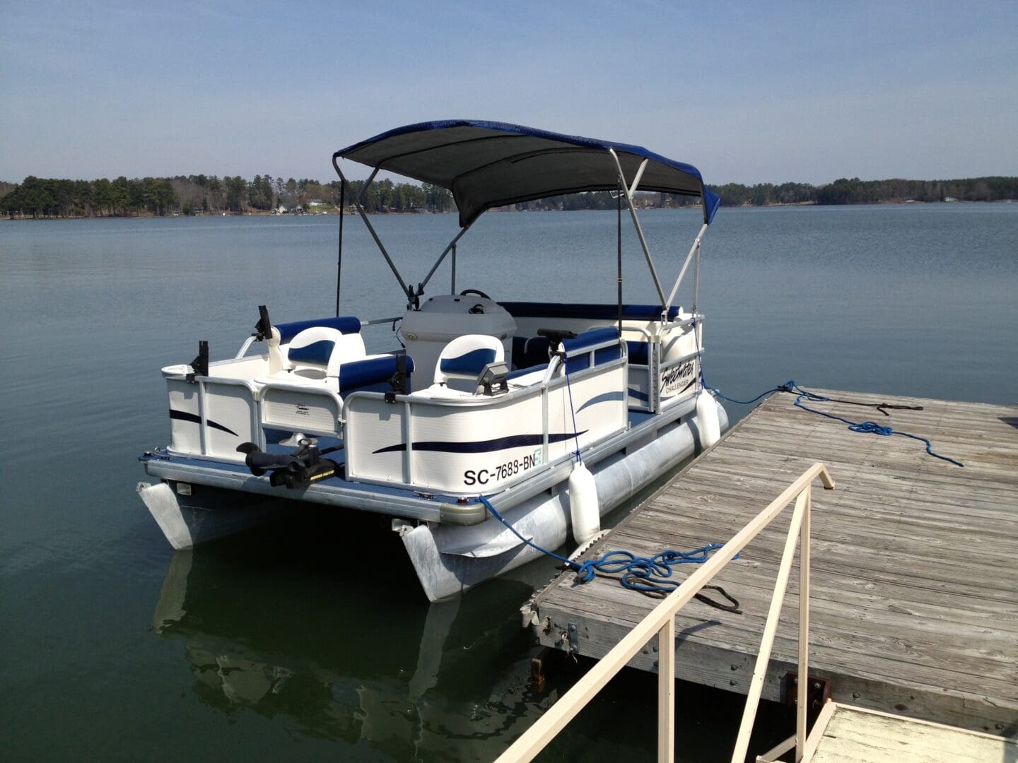 A boat is docked at the dock for passengers.